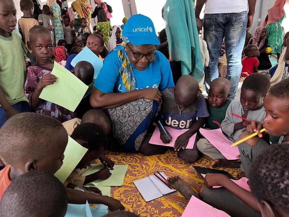 A UNICEF Chad child protection officer interacts with children in a Child-Friendly Space inside Farchana's Sudanese refugee camp, in eastern Chad.