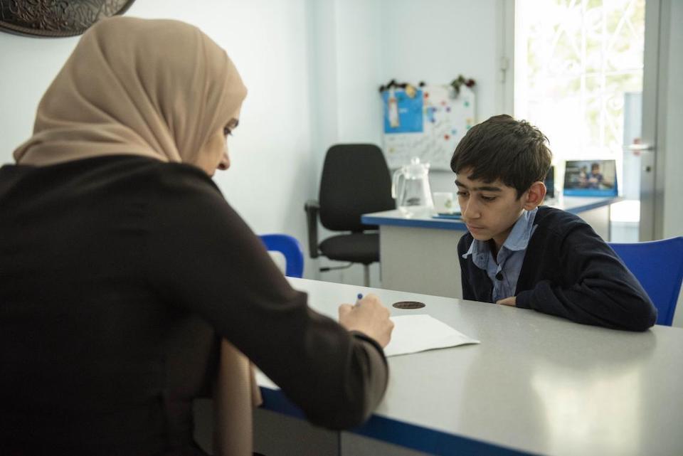 Osama, 14, during an individual psychosocial support session with his dedicated case manager, Salwa, at a UNICEF-supported center in Altal city, Rural Damascus, Syria.