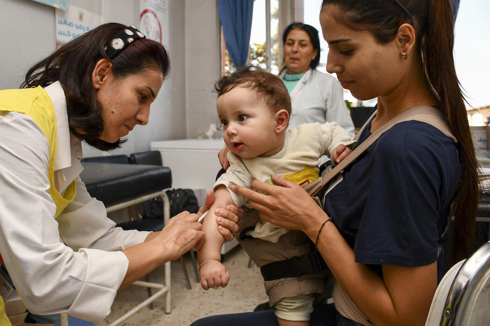 Julien, 8 months, receives his measles vaccine at a UNICEF-supported health center in As-Sweida city, southern Syria.