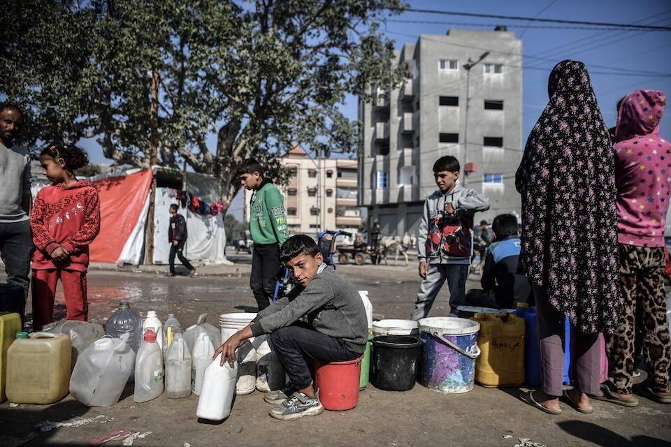 Muhammad, 11, waits in a line to collect safe water for his family in Rafah, southern Gaza Strip.