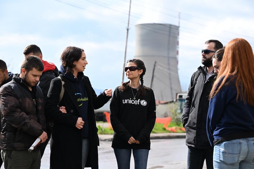 In Kosovo, UNICEF Ambassador Aria Mia Loberti, center, in dark glasses and UNICEF logo shirt, meets with young climate activists speaking out about environmental pollution in their community. 
