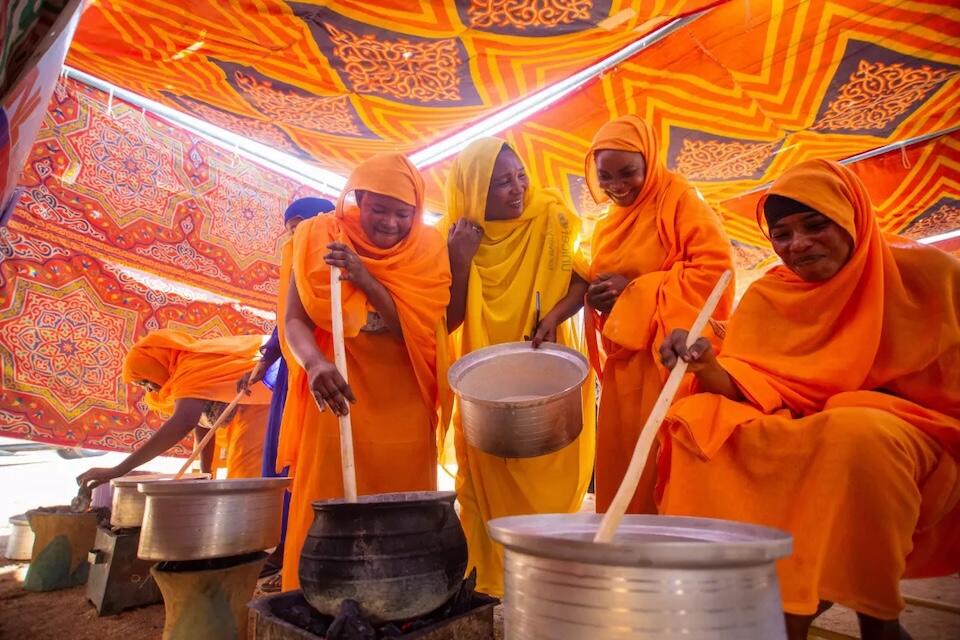 In Elradeef village in Kassala state, Sudan, Muzdalifa, in yellow, leads a cooking demonstration as part of a UNICEF-supported community initiative where mothers train other mothers to promote healthy diets and feeding practices and prevent malnutrition, a chronic issue in the country.