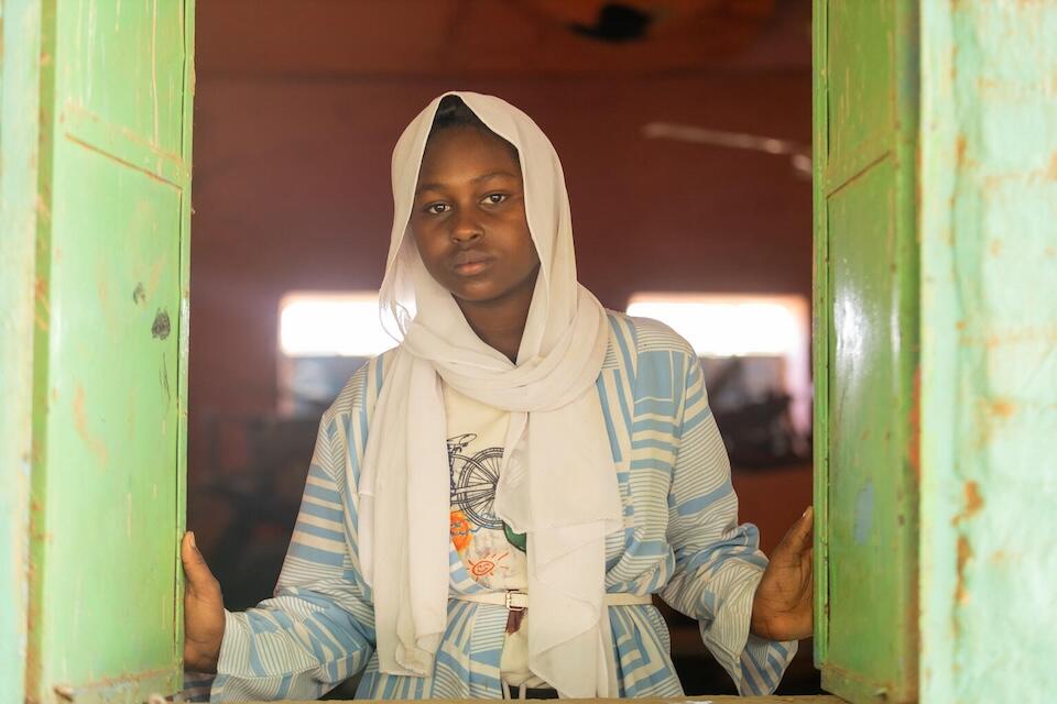 Walaa, 15, stares through a window at the UNICEF-supported Alshargia safe learning space or Makanna in Kassala State, Sudan. 