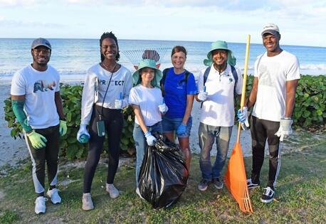 UNICEF Youth Advocate Maria, center, with fellow climate activists, led an environmental clean-up in Oistins, a fishing town in Barbados, in March 2024. 